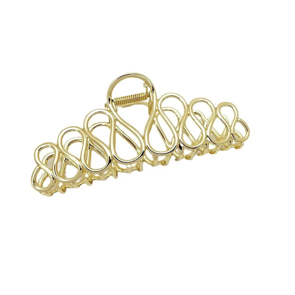 Large gold and silver alloy hair clip with a minimalist design and tassel detail for updo hairstyles.