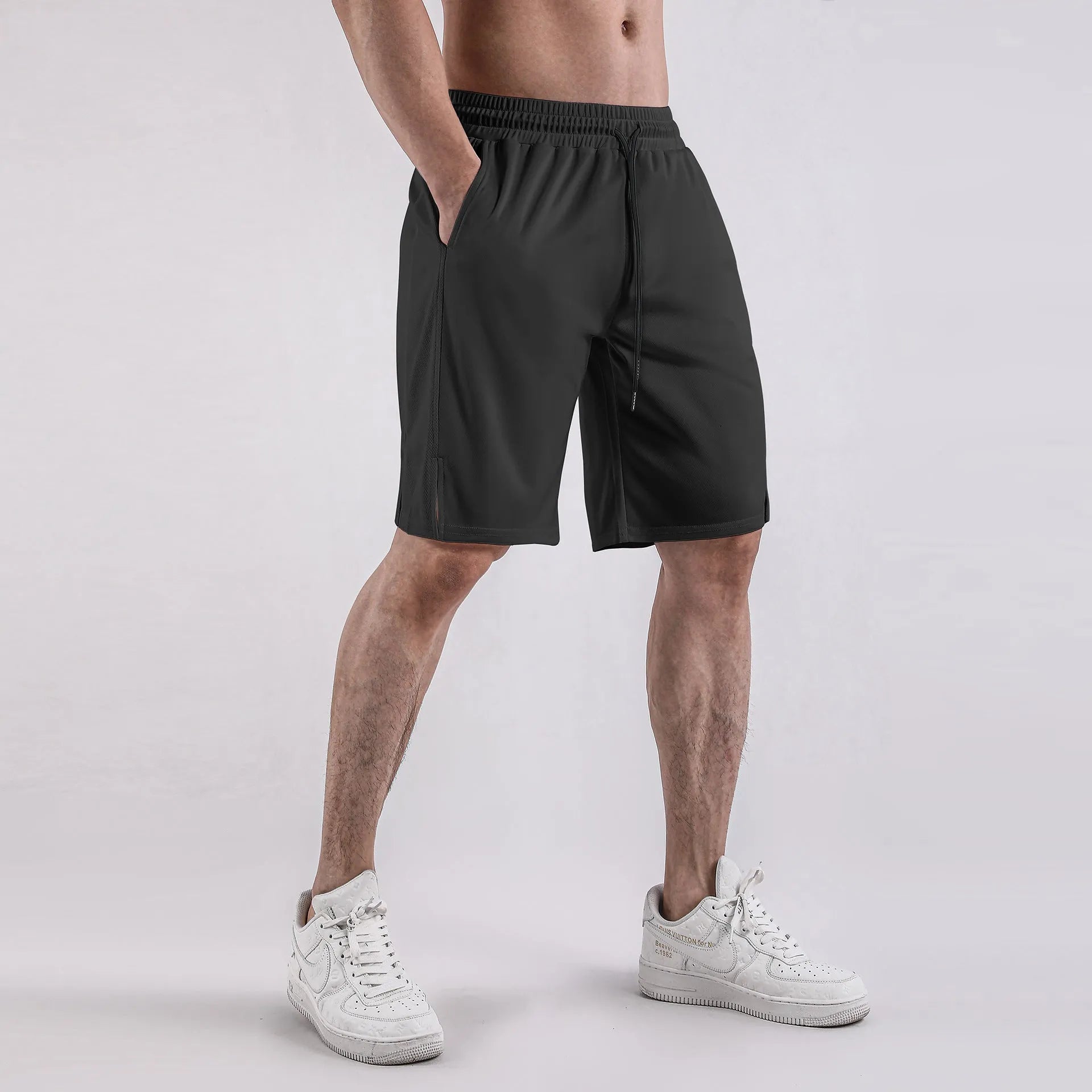 Men's quick-drying mesh shorts in black with elastic waistband and loose fit design