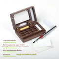 Mini walnut wood watercolour paint box open to show pigment pans inside