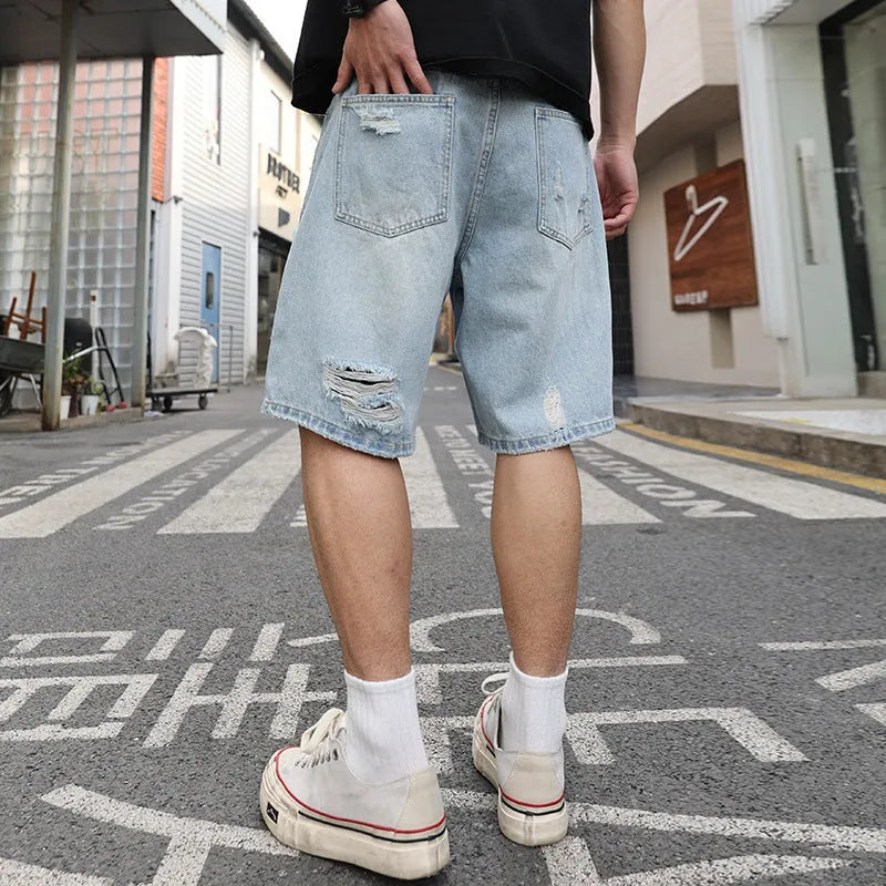 Men's light blue loose fit ripped denim shorts with distressed detailing and straight cut hip hop style