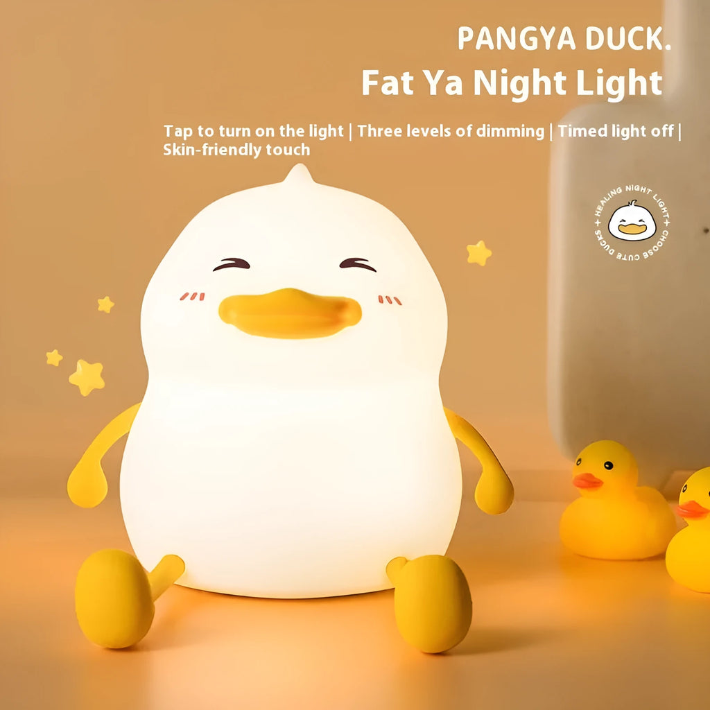 Chubby Night Light desk lamp showing soft glow, phone holder slot, and compact silicone design.