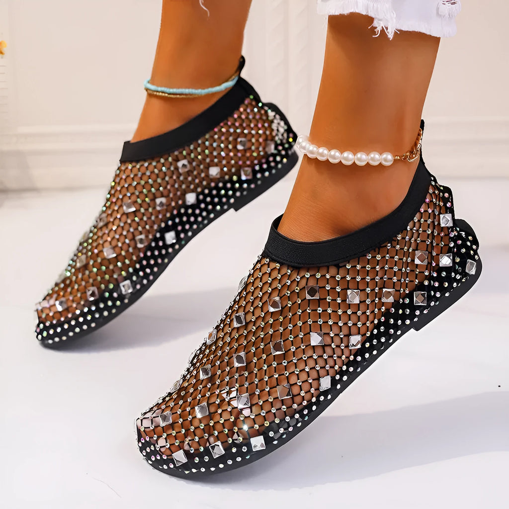Women's white mesh flat sandals with colourful rhinestone decoration and a rubber sole.