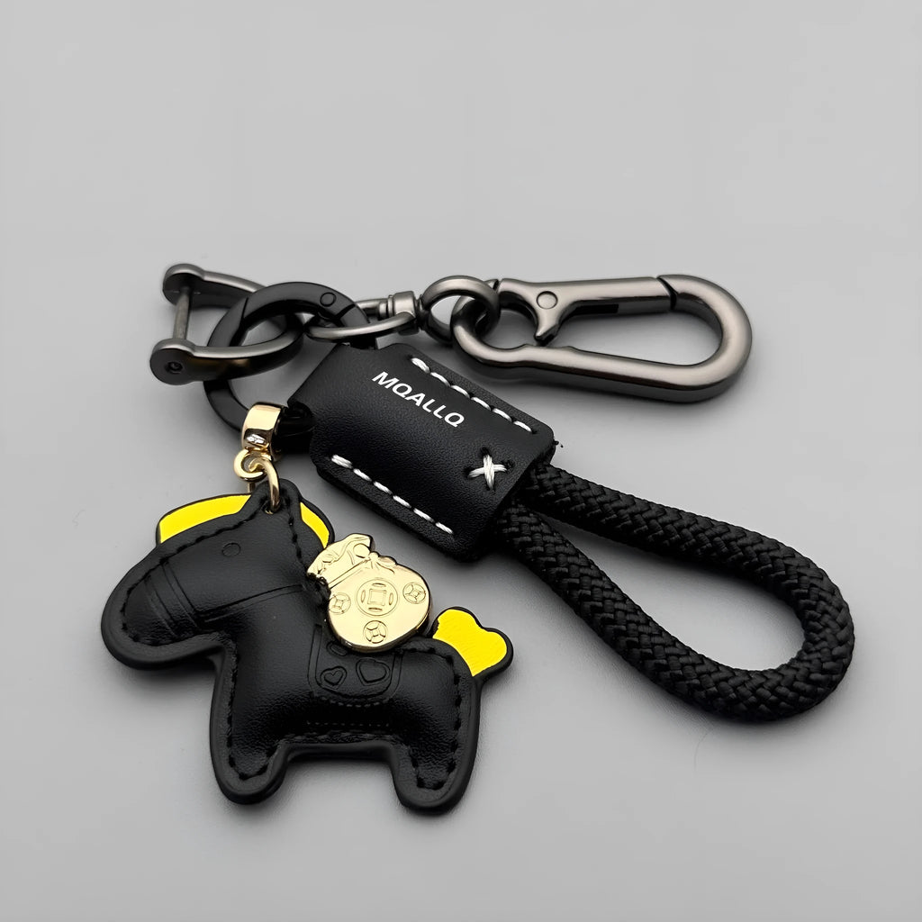 Handmade brown cowhide leather key ring with a gold pony belt buckle charm and a green flanelle rope loop.