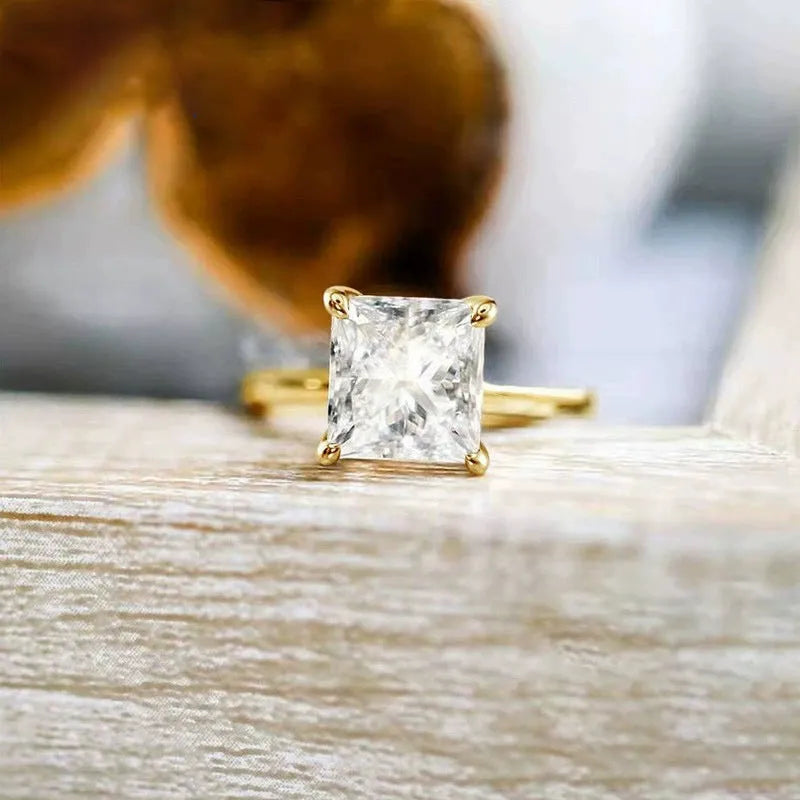 A geometric 925 silver women's ring with a round zirconium stone, shown in gold, rose gold, and silver finishes.