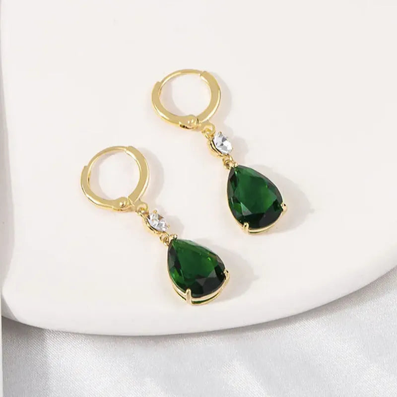 A pair of emerald green geometric teardrop earrings made from alloy.
