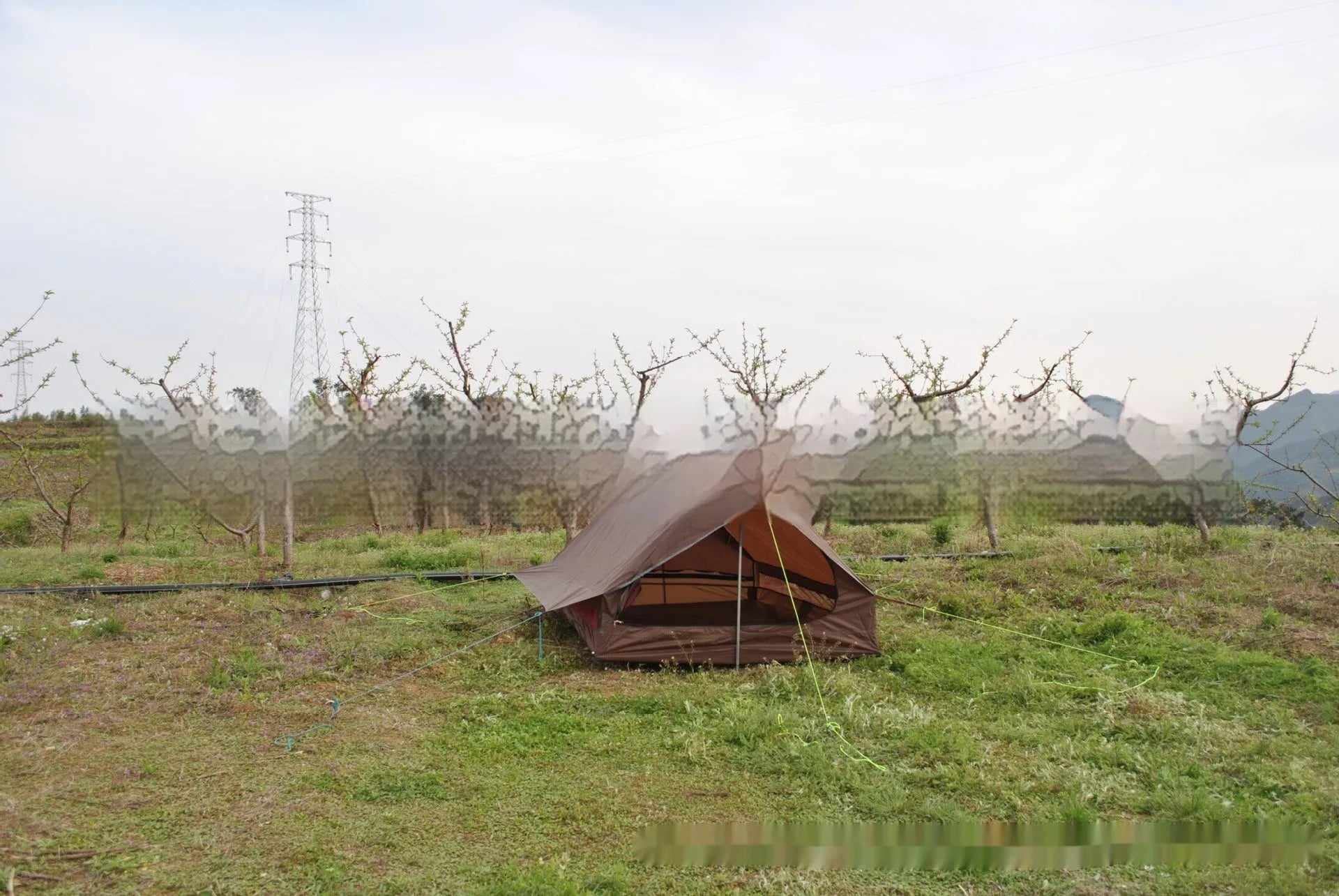 Brown A-line cabin tent setup with hiking pole supports showing spacious interior and waterproof fabric construction
