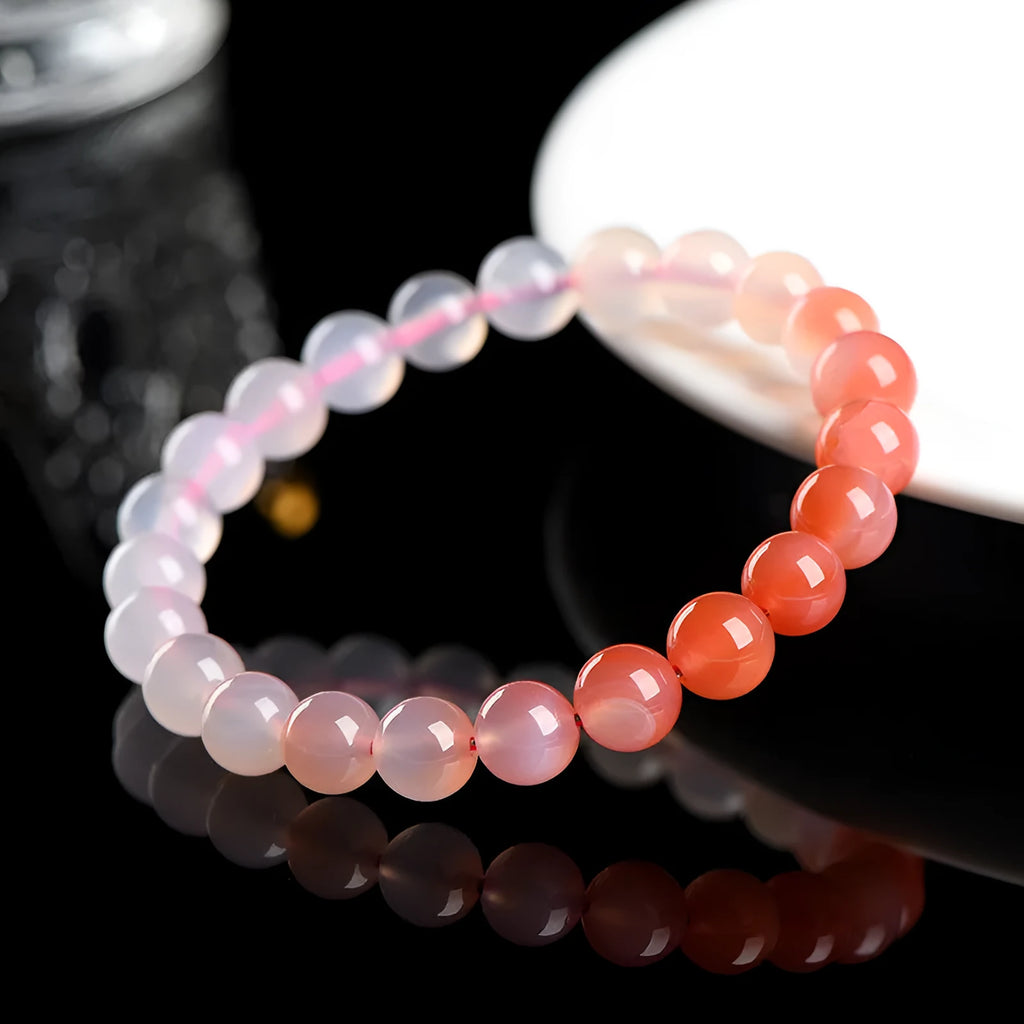 Natural gradient Yanyuan agate bracelet with geometry-cut beads on a wrist, showing salt source colour variation.