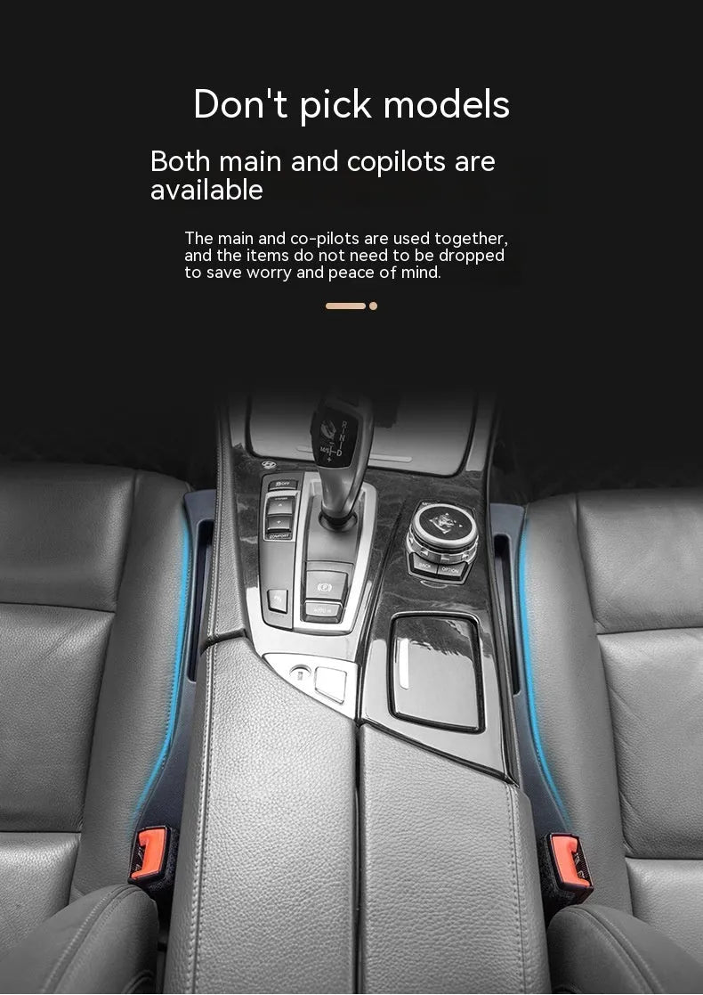 Black plastic car seat gap storage box with removal handle inserted between vehicle seats