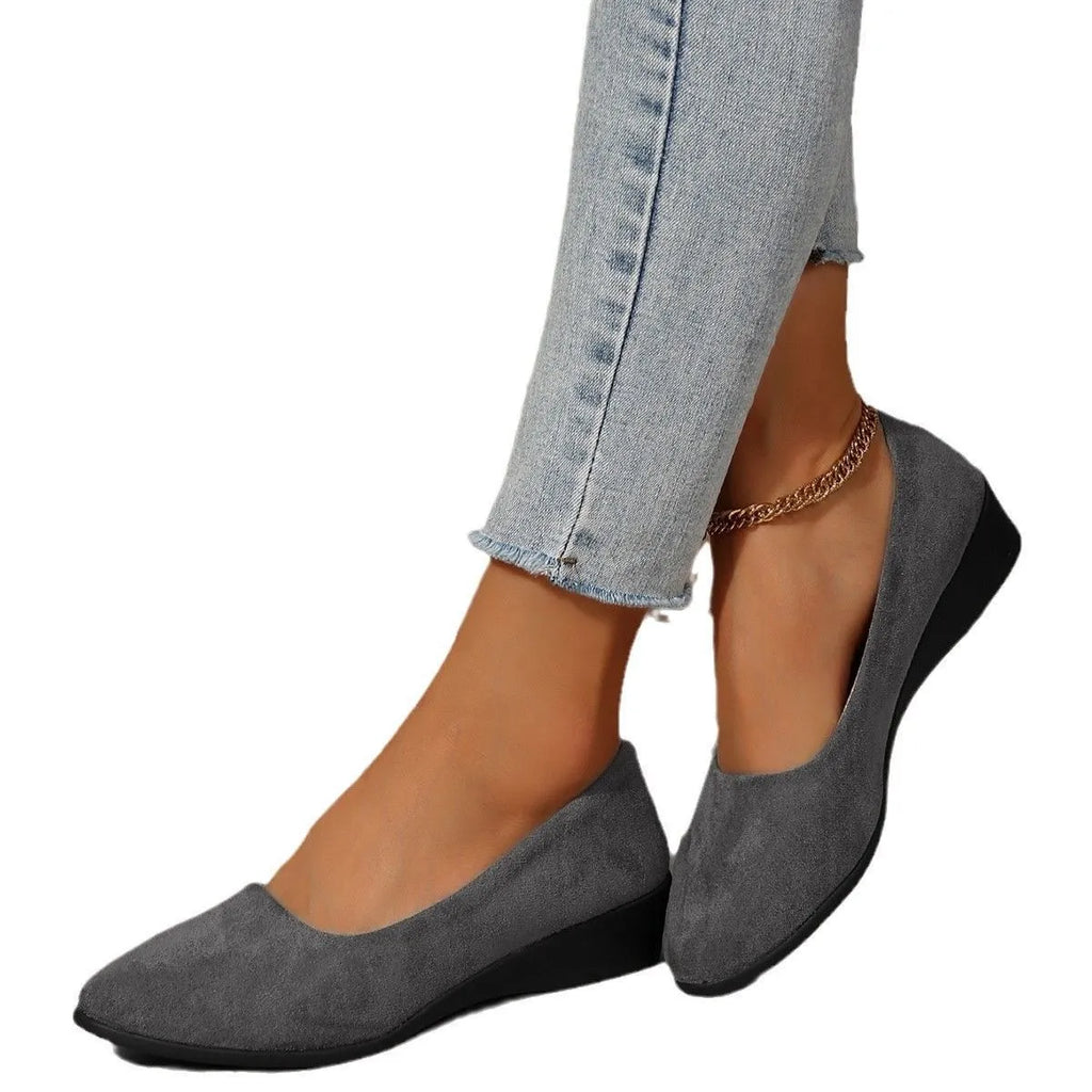 Women's black suede wedge pumps with a low block heel and pointed toe on a rubber sole.