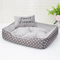 Polka dot printed square small dog bed with matching embroidered pillow in grey, blue, pink, or red colours.