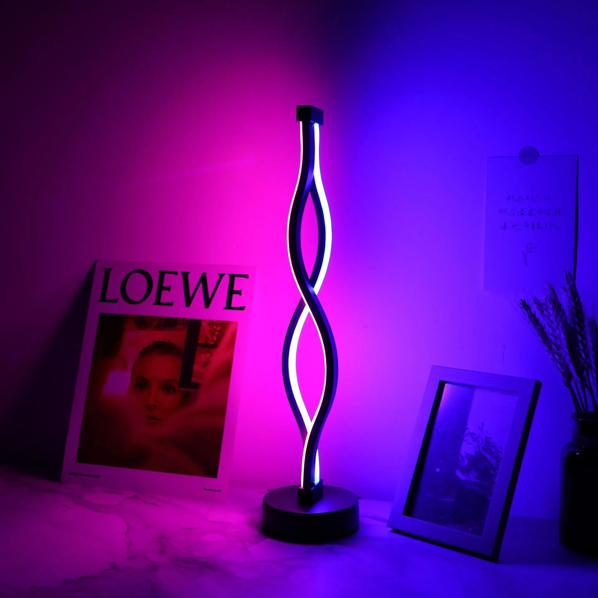 Black aluminium desk lamp with touch dimming controls and three-colour lighting options