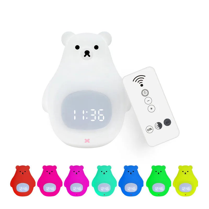 White silicone cartoon bear night light with remote control on a table.