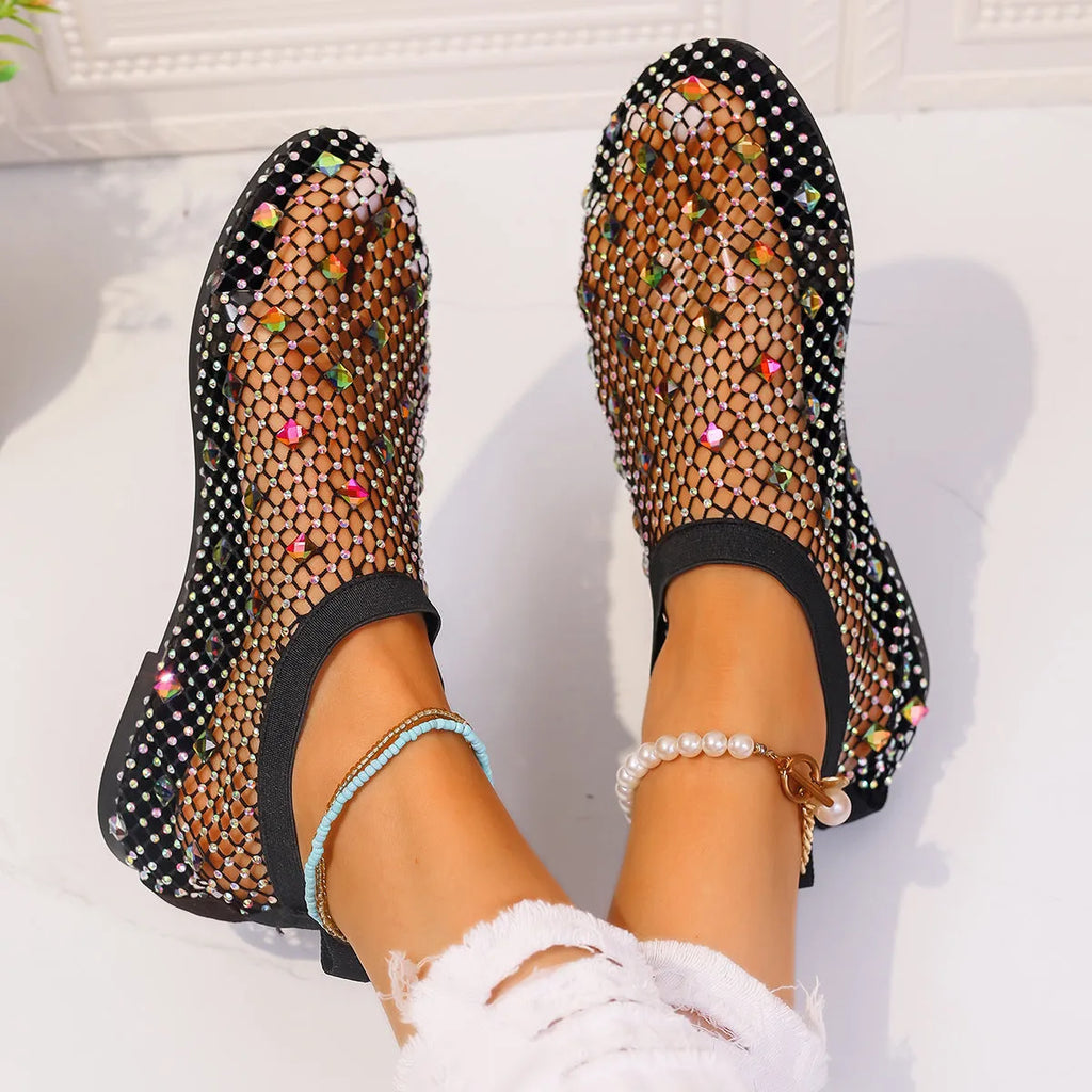 Women's white mesh flat sandals with colourful rhinestone decoration and a rubber sole.