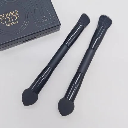 Elegant black double-headed makeup brush with a concealer brush and angled miter sponge on a wooden handle.