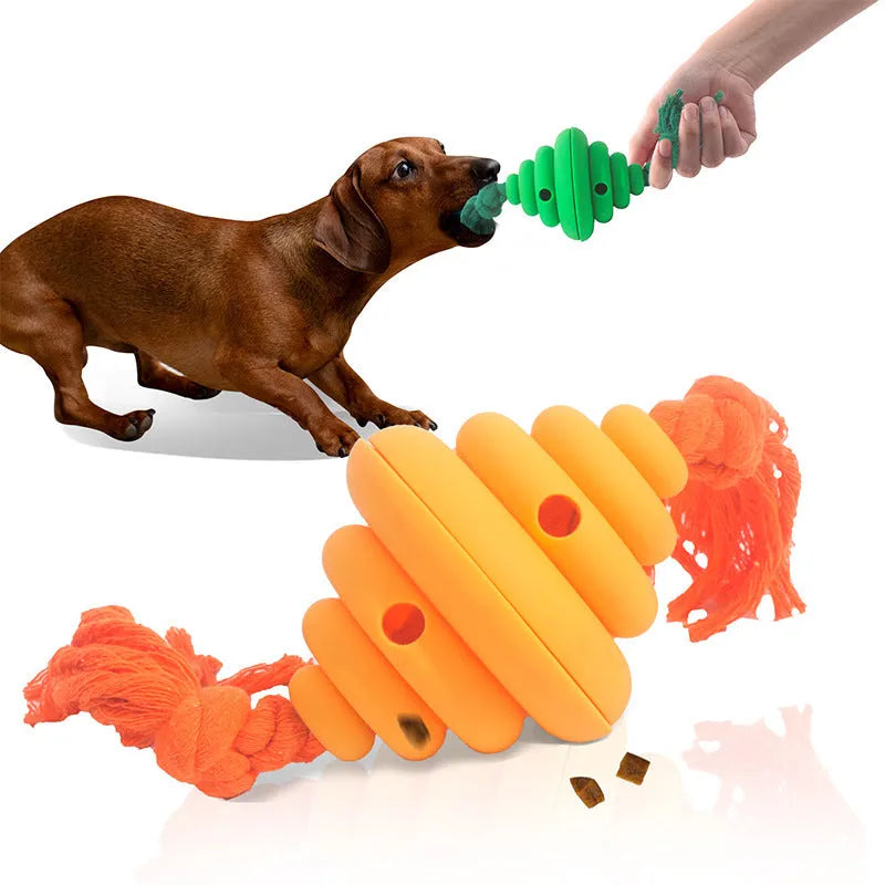 Green and yellow silicone dog ball with attached knot rope toy on grass.