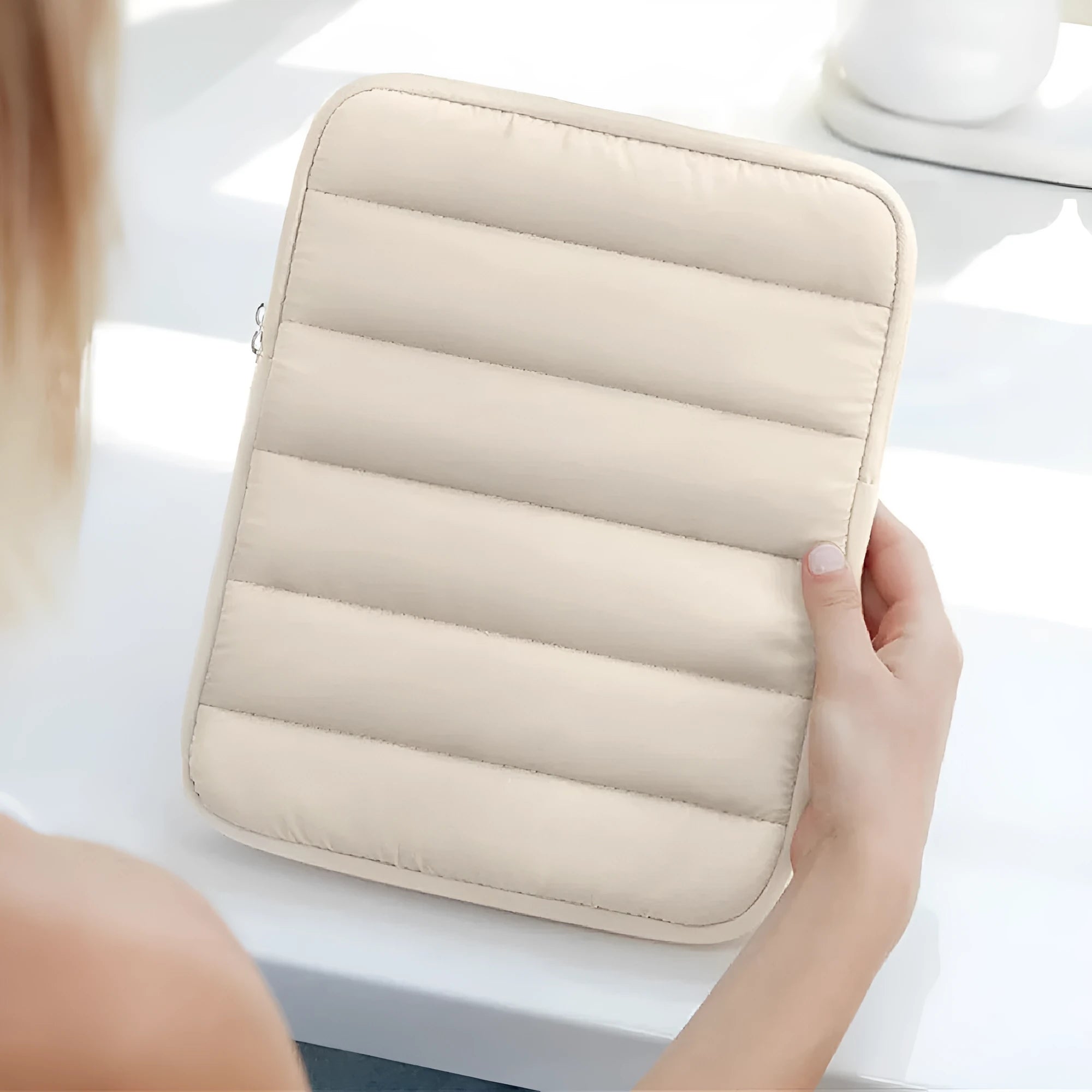 Fluffy air feeling laptop sleeve in black, open to show soft lining, next to an 11 inch tablet.