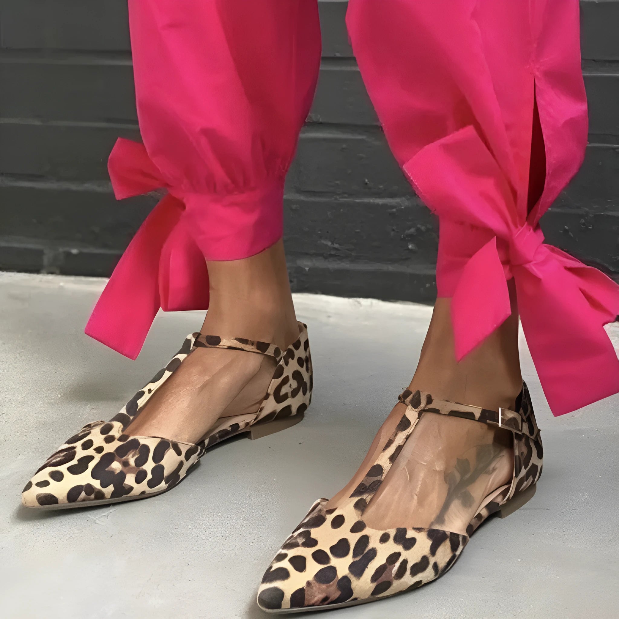 Leopard print women's pumps with a pointed toe, cross straps, and a chunky low heel.