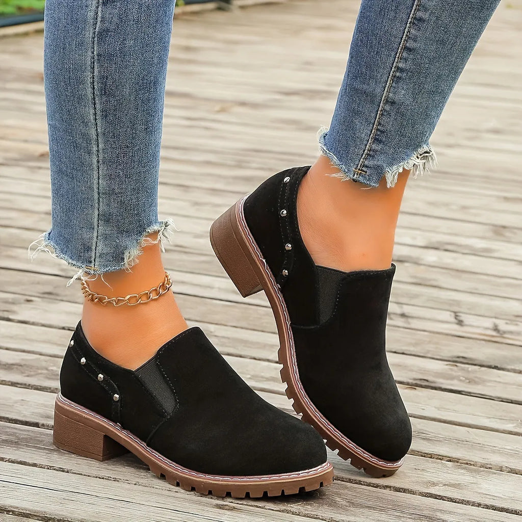 Light brown suede women's ankle boots with low heel and elastic band on a white background.