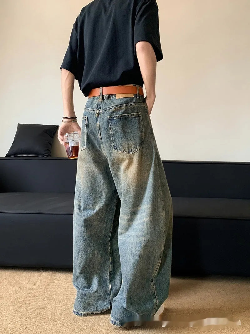 Men's retro blue distressed jeans with machete wash pattern and wide-leg design
