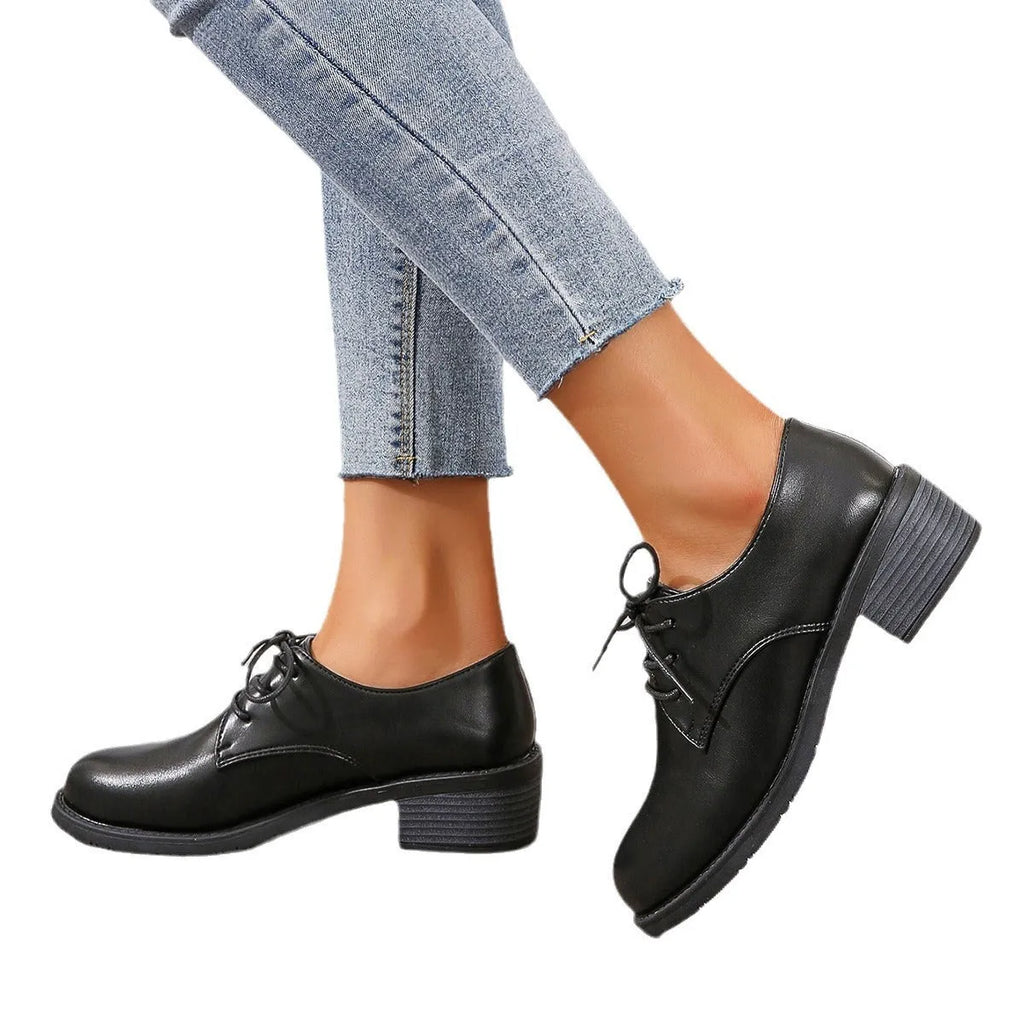 Black women's low-top work shoes with a thick chunky heel and rounded toe.