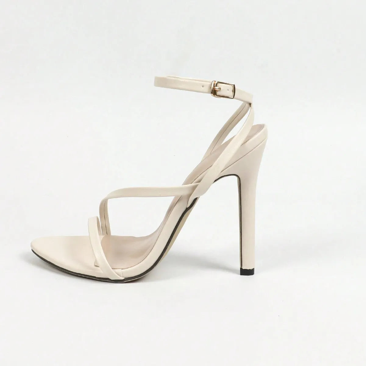 Gold women's high heel sandals with open round toe and cross ankle straps on a white background.