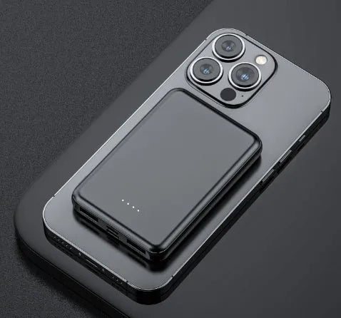 Black rectangular electric heating vest power bank with USB port, shown next to a measuring tape.