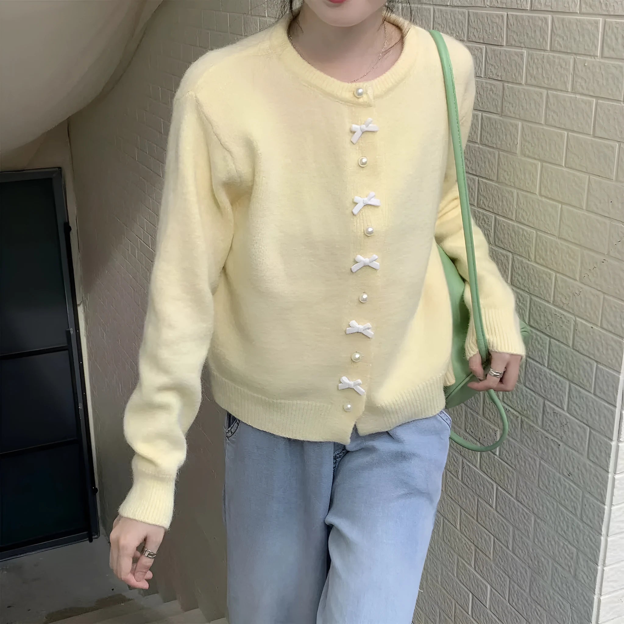 Women's solid colour sweater cardigan with bow detail and pearl buttons