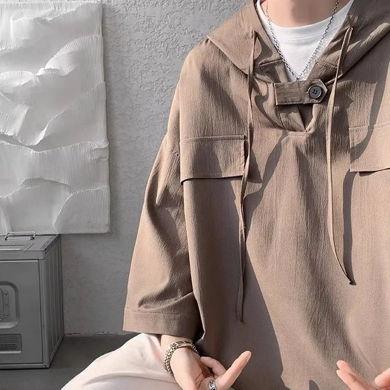 Man wearing black hooded short sleeve T-shirt with loose fit for summer casual wear
