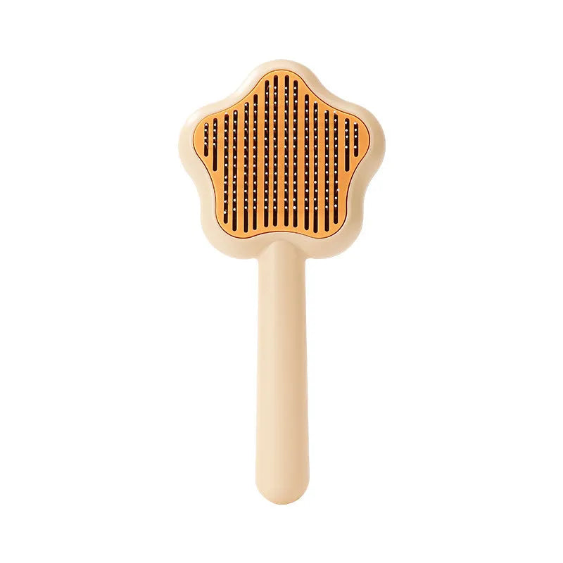 Green self-cleaning stainless steel pet comb with removable needle head on a white background.