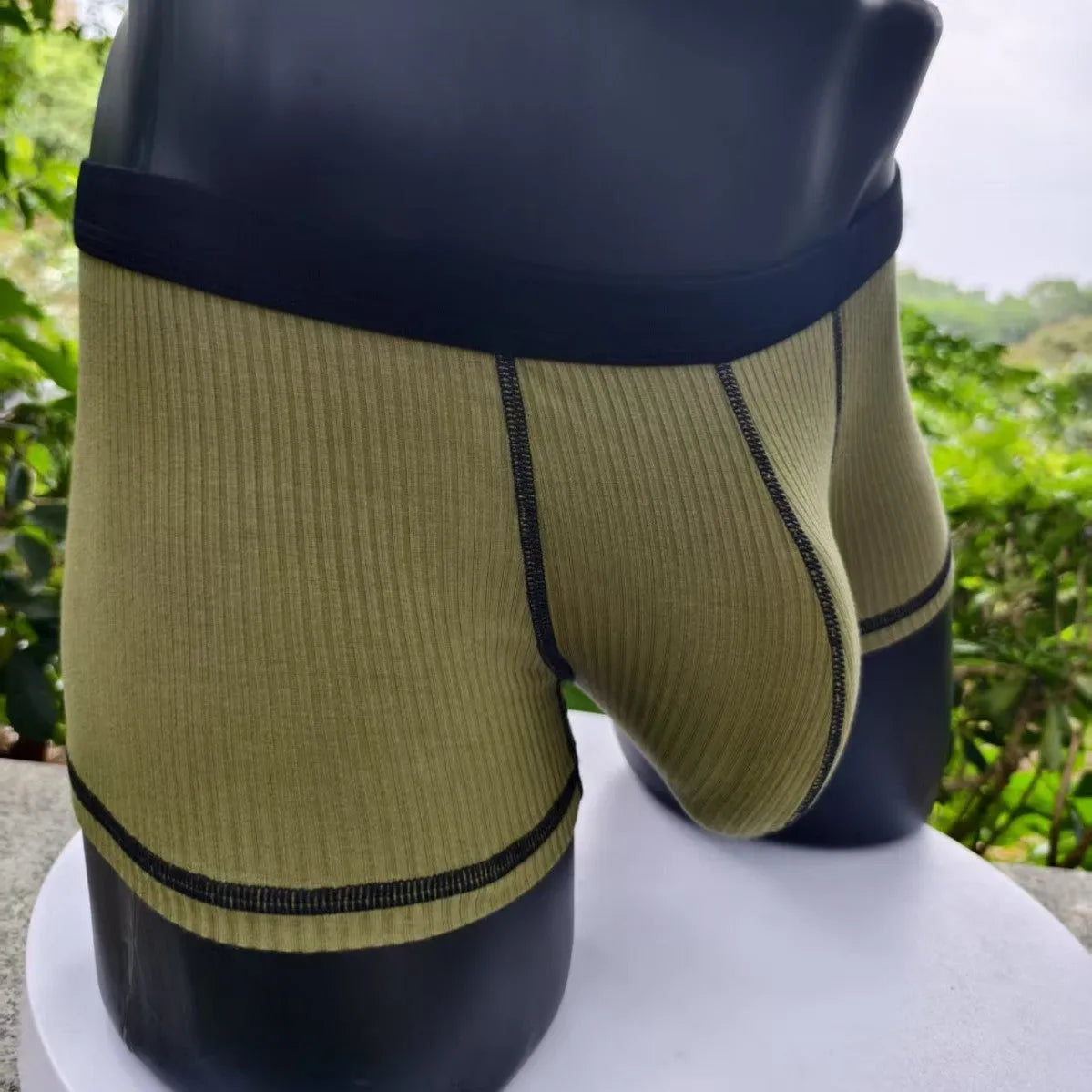Men's thin fabric boxer shorts in solid colours showing hip lifting design