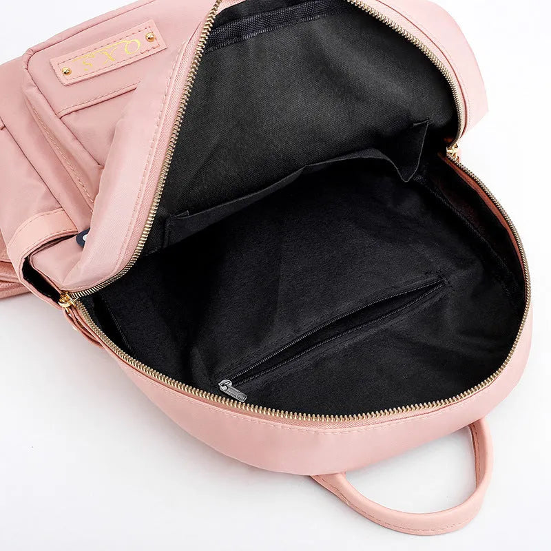 Black women's casual nylon backpack showing square vertical shape with shoulder straps and external pockets