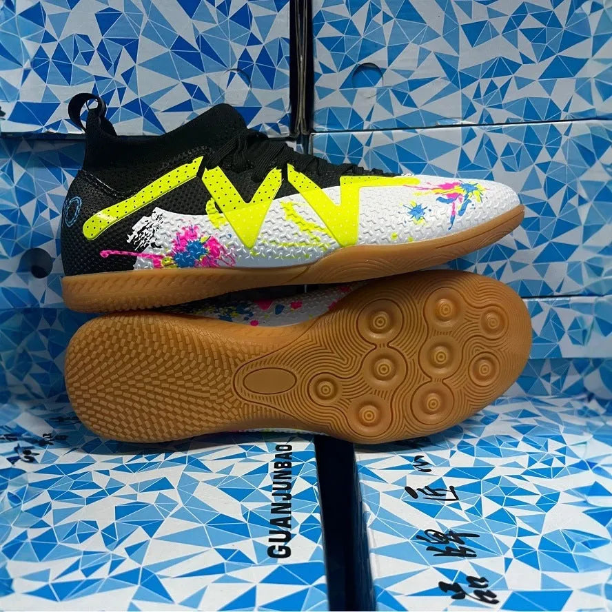 Low-top soccer boots in black and yellow colourway with spiked rubber sole, shown on a firm ground surface.