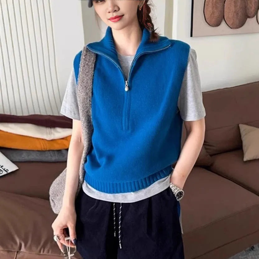 Orange sleeveless half-zip mesh knit vest on a hanger, casual style.