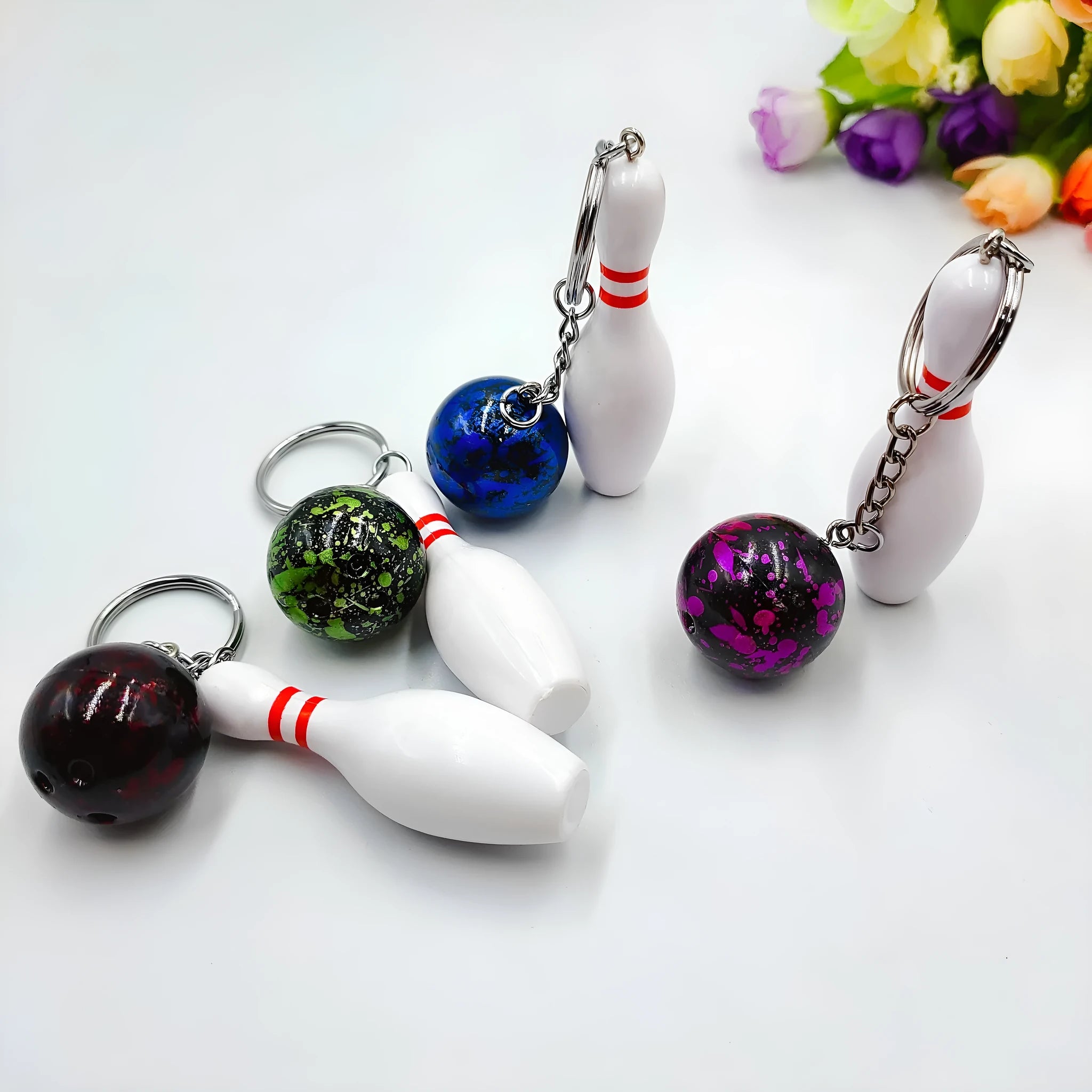 Mini bowling simulation keychain pendant in PVC metal showing four colour options