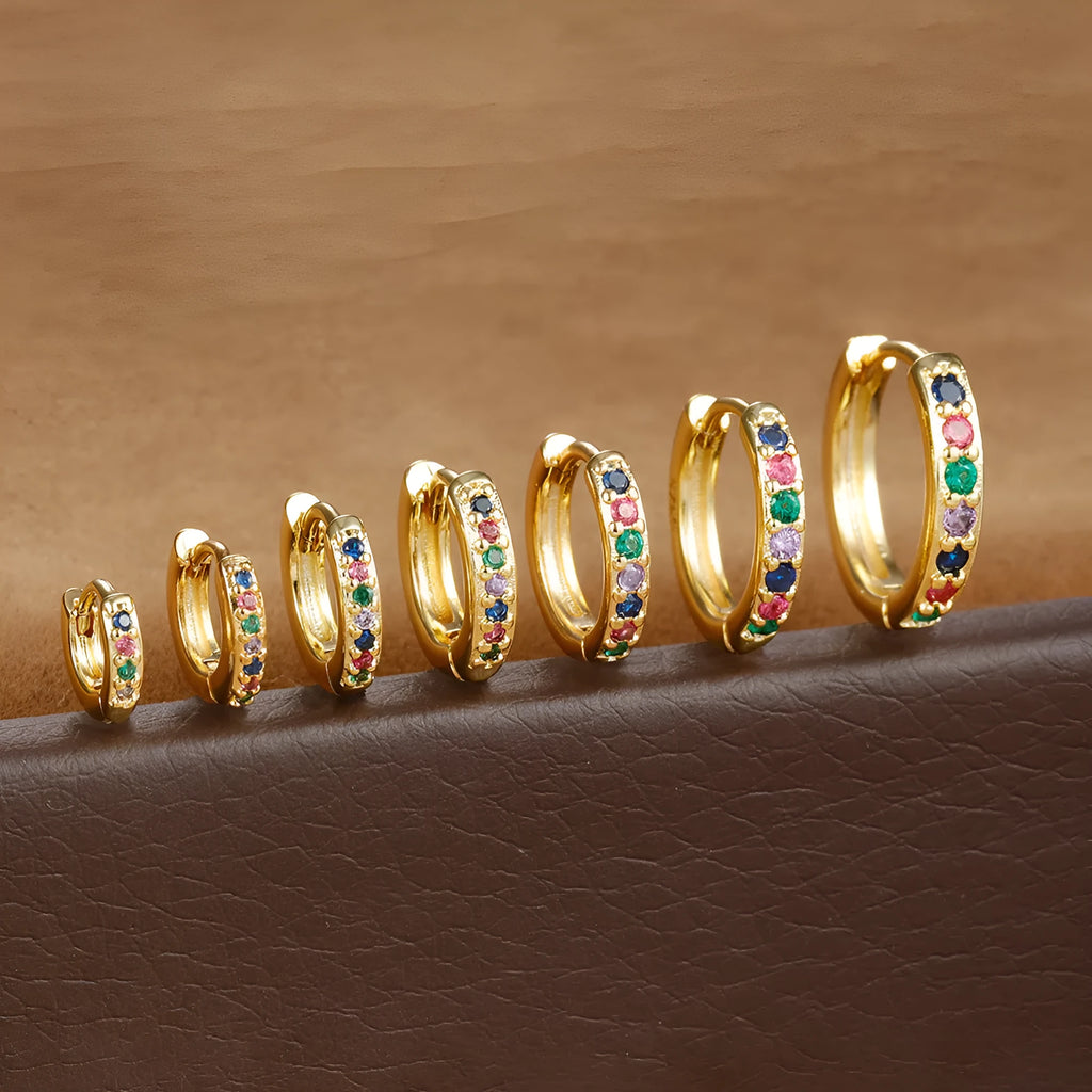Perforated circle zircon stud earrings in gold, rose gold, or silver colour on white background