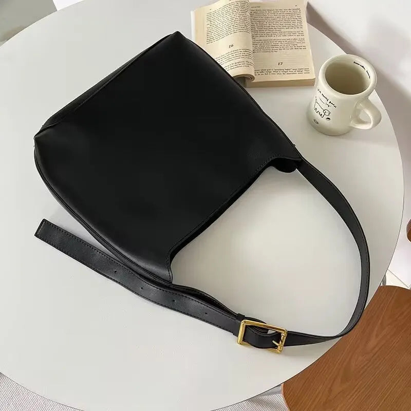 Soft black and brown PU leather ladies shoulder bags with swing thread decorative detail.