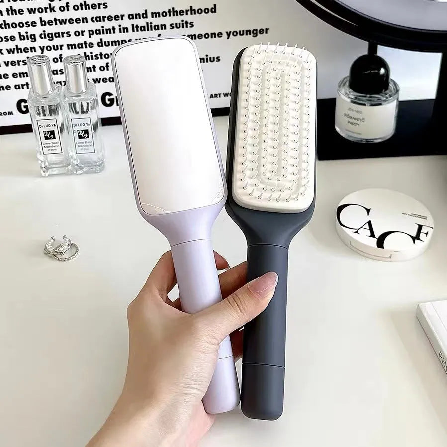 Roland purple self-cleaning hair brush with rotating handle and anti-static massage bristles.