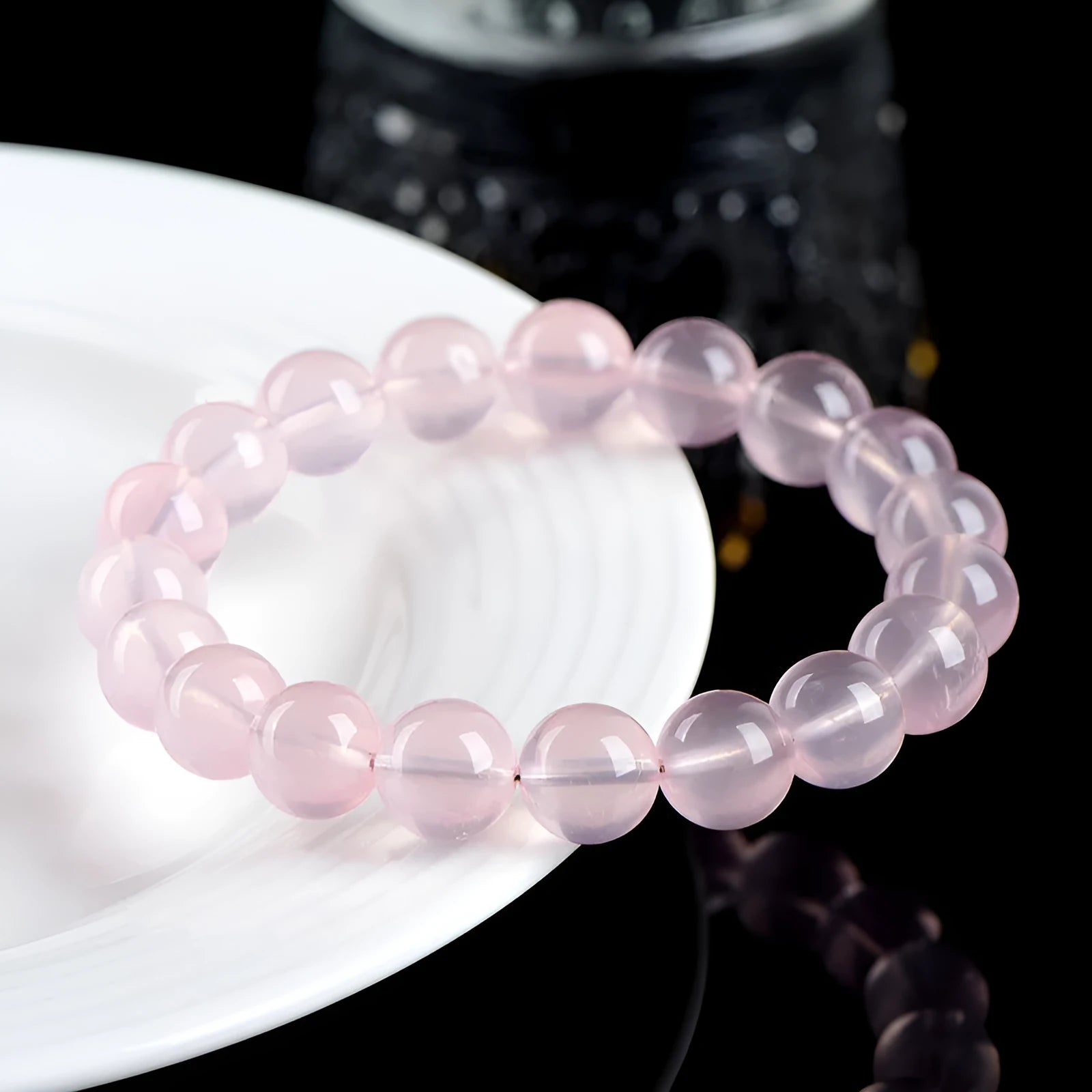 Natural Starlight Crystal round bead bracelet in pink, showing polished finish on wrist.
