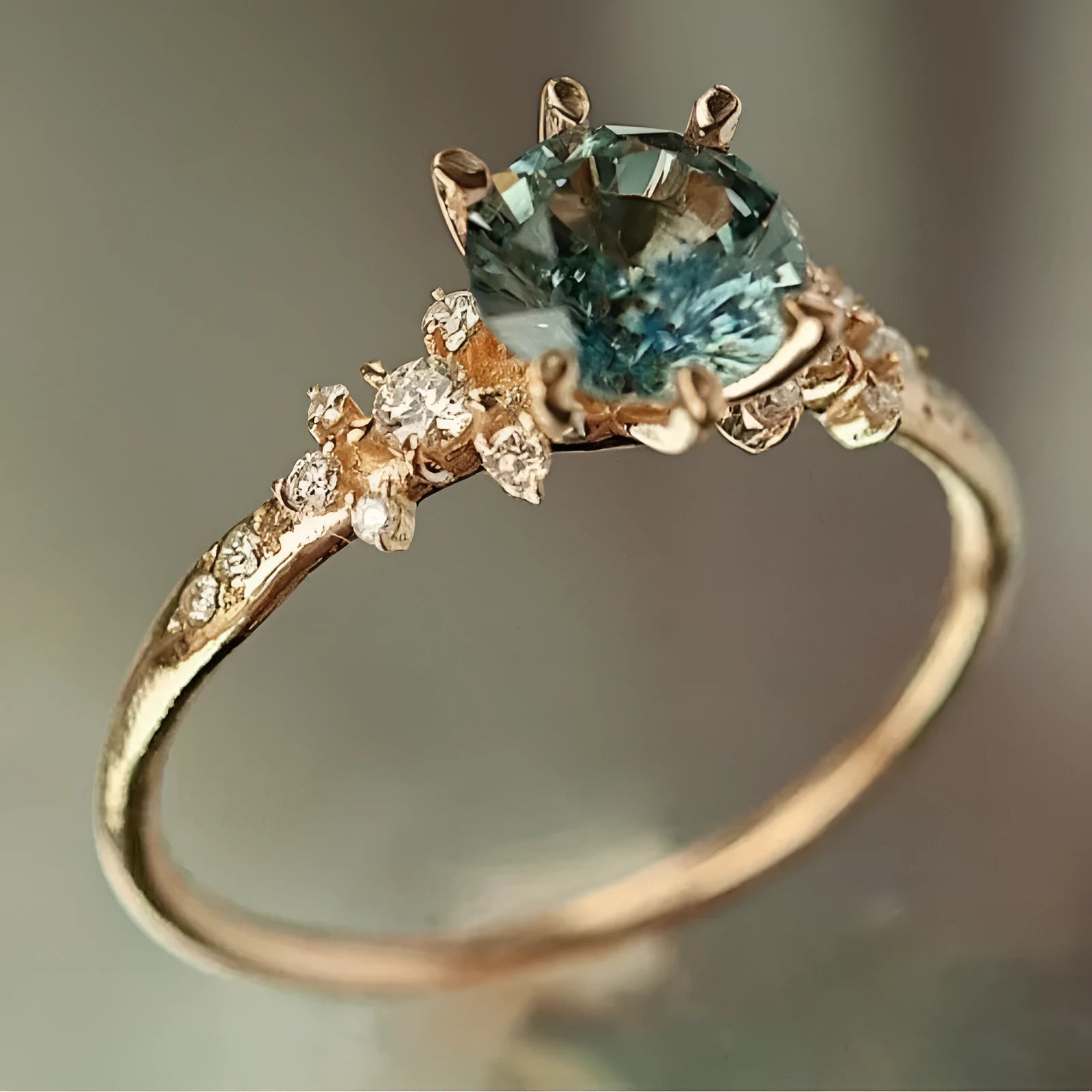 Gold plated geometric ring with a claw-set zircon stone in a chamfered square pattern.
