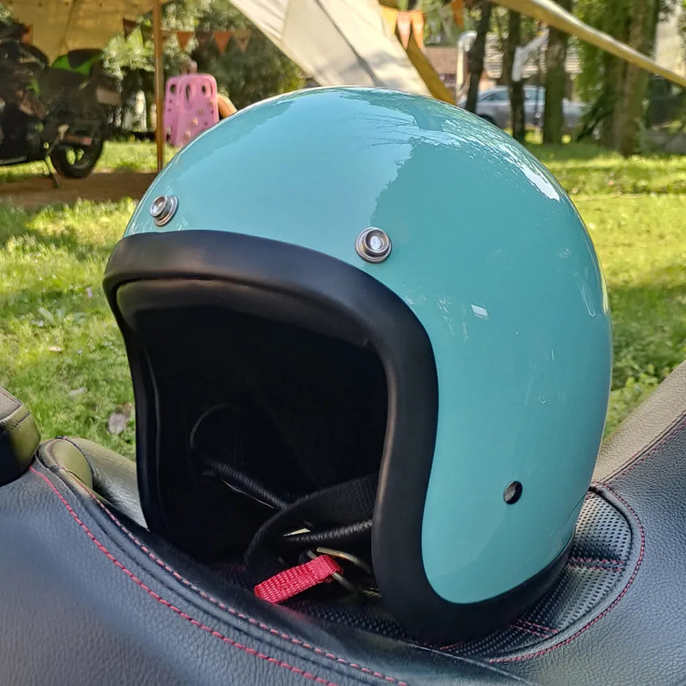 Glass fibre motorcycle half helmet shown in a retro style on a stand.