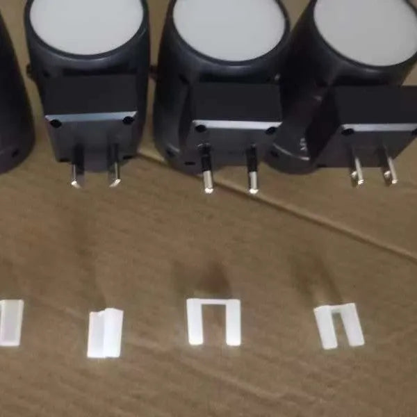 Small adjustable brightness night lamp with rotatable direct plug showing warm light illumination