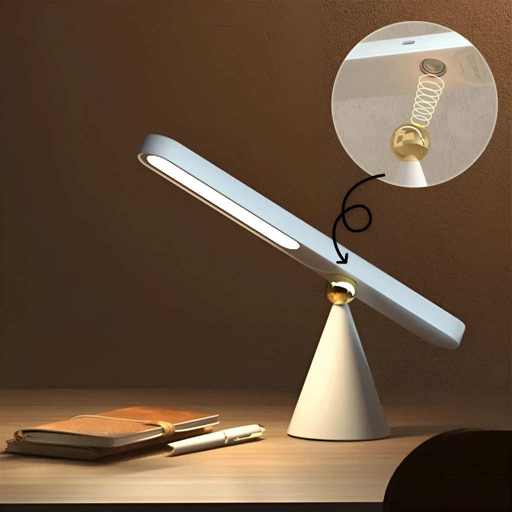 White geometric desk lamp with USB cable and magnetic base for wall mounting.