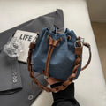 Blue synthetic leather cross body bucket bag with shoulder strap and organised pocket compartments