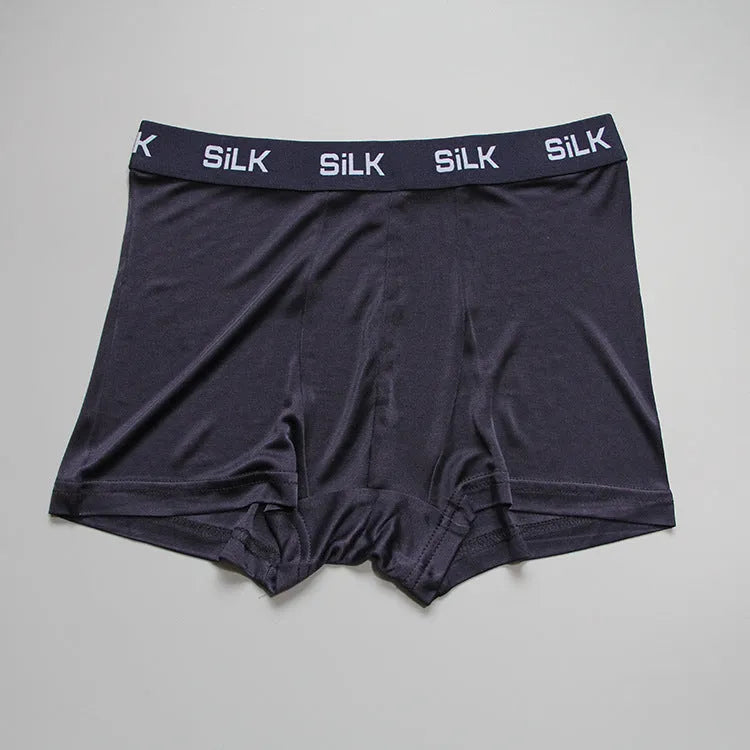 Men's casual silk shorts in navy blue, shown with a loose fit and mid waist design