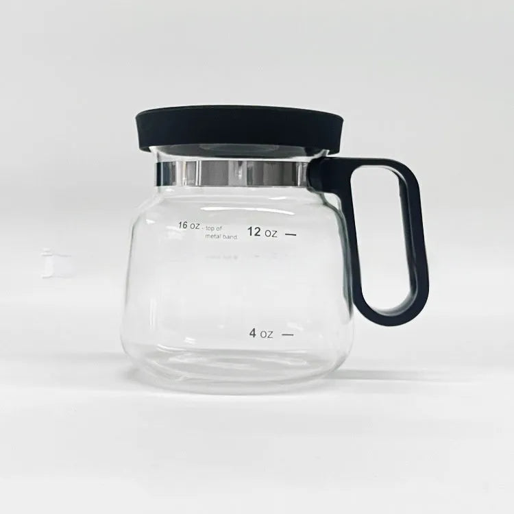 Transparent borosilicate glass coffee maker with black silicone cover on a kitchen counter.