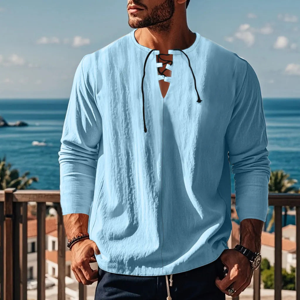 Cotton linen beach ruff shirt in a loose pullover style on a hanger.