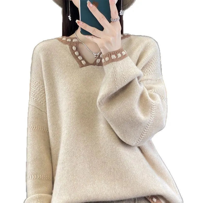 White women's V-neck long sleeve pullover sweater made from viscose knit fabric on a hanger.
