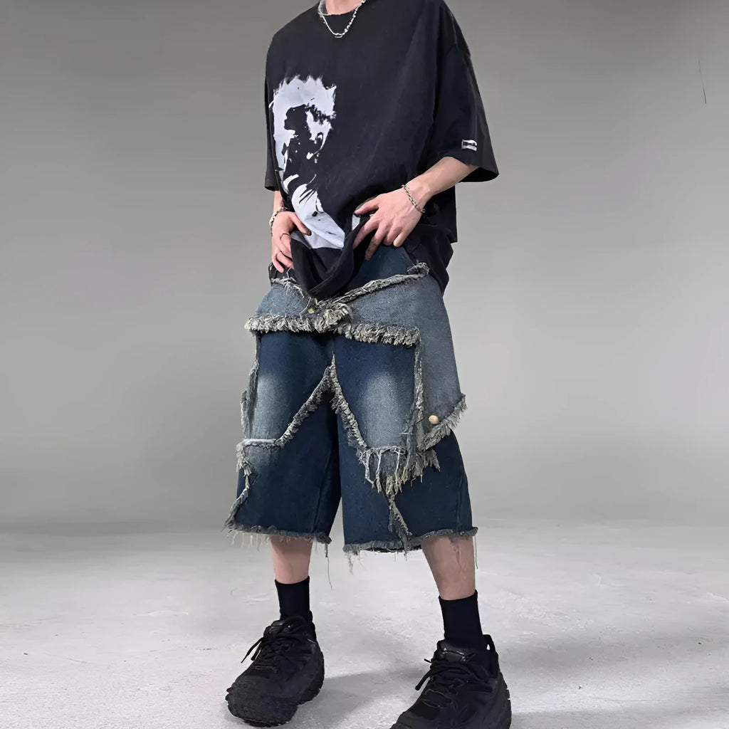 Blue denim shorts with frayed hem and star detail shown in loose fit style