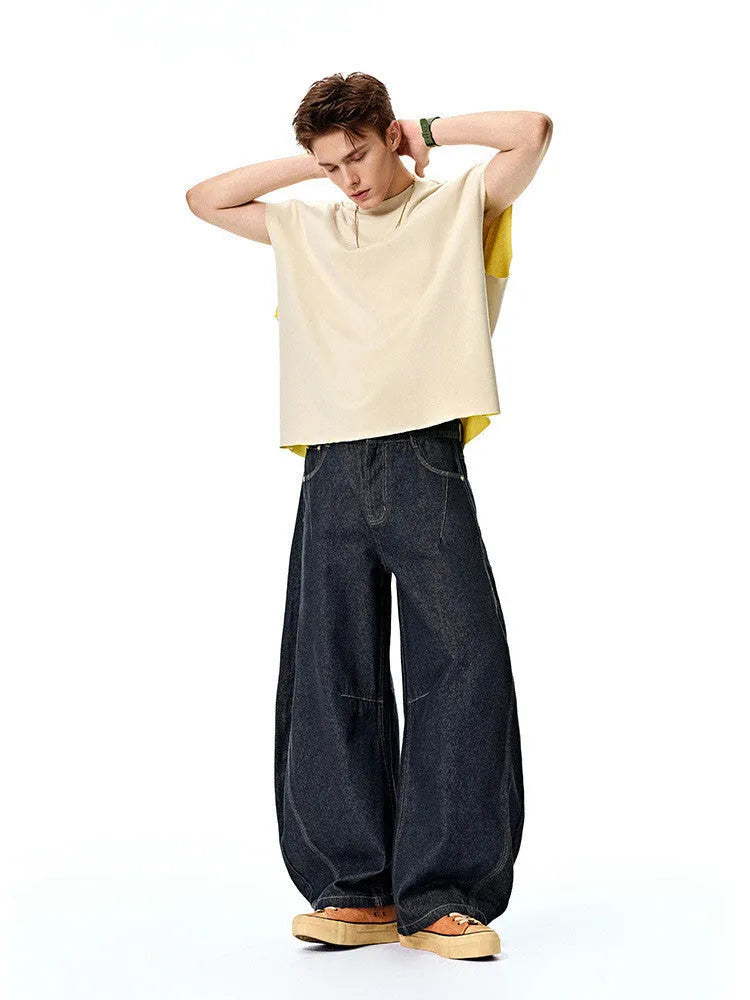 Men's wide leg denim trousers in original cow colour showing mid-waist design and relaxed fit