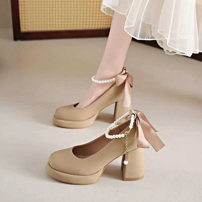 Women's beige Mary Jane shoes with a chunky heel and silver ankle-strap buckle on a round toe PU upper.